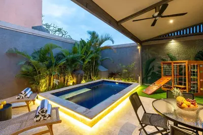 a swimming pool in the backyard of a house at Central 3bd Modern Villa with Private Pool and Play Area in Kerobokan