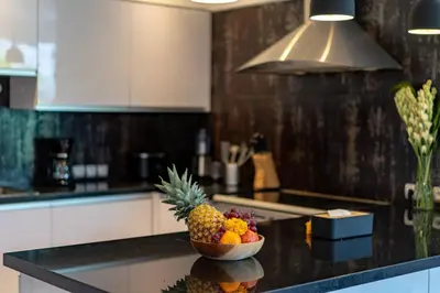 a bowl of fruit on a counter in a kitchen at Central 3bd Modern Villa with Private Pool and Play Area in Kerobokan