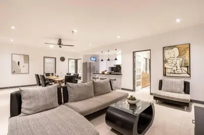 a living room with a couch and a table at Central 3bd Modern Villa with Private Pool and Play Area in Kerobokan