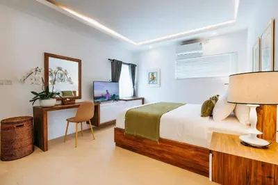 a bedroom with a bed and a desk and a television at Spacious 4 Bedroom Private Villa in buzzy of Seminyak in Canggu