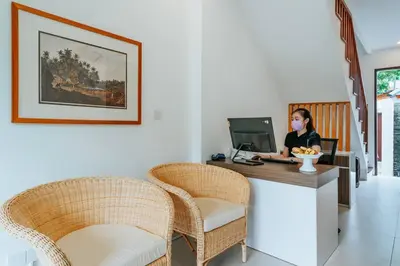 a woman sitting at a desk with a computer at Spacious 4 Bedroom Private Villa in buzzy of Seminyak in Canggu