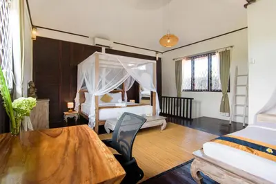 a bedroom with two beds and a table and a bed at Private villa with pool near 66 in Seminyak in Seminyak