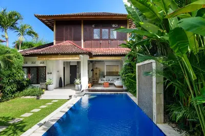 a villa with a swimming pool in front of a house at Private villa with pool near 66 in Seminyak in Seminyak