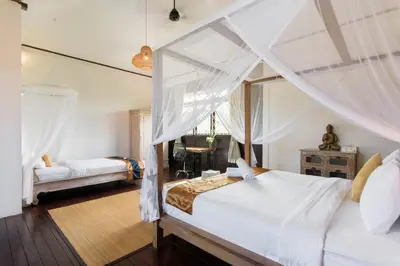 a bedroom with a white bed with a canopy at Private villa with pool near 66 in Seminyak in Seminyak