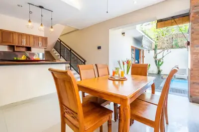 a kitchen and dining room with a wooden table and chairs at New Villa Lotus 2BR Private Pool Villas in Seminyak