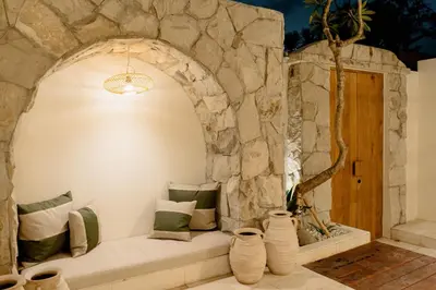 a stone walled room with a bench in front of a window at VILLA HAWILA 2BR OBEROI SEMINYAK PRIME LOCATION - No FLOOD in Seminyak