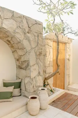 a stone wall with two vases next to a door at VILLA HAWILA 2BR OBEROI SEMINYAK PRIME LOCATION - No FLOOD in Seminyak