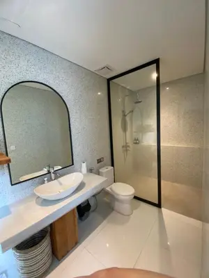 a bathroom with a sink and a toilet and a mirror at VILLA HAWILA 2BR OBEROI SEMINYAK PRIME LOCATION - No FLOOD in Seminyak
