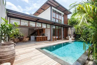 a house with a swimming pool in front of it at Luxury 3bd Villa 5 Min From Berawa Beach in Canggu