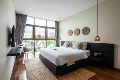 a bedroom with a large bed and a large window at Luxury 3bd Villa 5 Min From Berawa Beach in Canggu