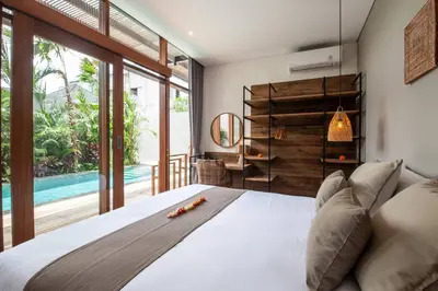 a bedroom with a large bed and a pool at Luxury 3bd Villa 5 Min From Berawa Beach in Canggu