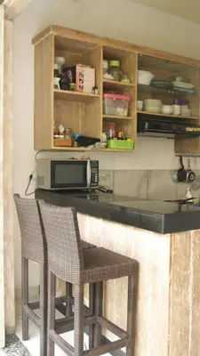 a kitchen with two chairs and a counter at Sugiras Living in Denpasar