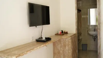 a flat screen tv hanging on a wall at Sugiras Living in Denpasar