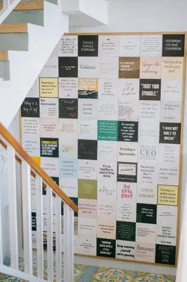 a wall of signs on the side of a staircase at Casa Amarta Canggu - Boutique Lofts & Detox SPA in Canggu