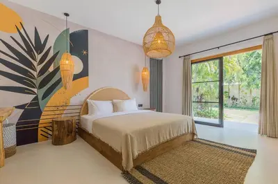 a bedroom with a bed and a large window at Villa Alamanda Livia Seminyak Design spacious 2bdr and private pool in Seminyak