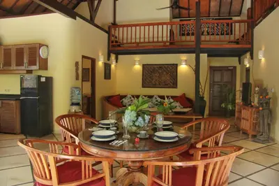 a dining room with a wooden table and chairs at Villa Yauda - Charming 3BR w/Private pool & Garden in Seminyak