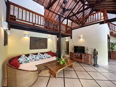 a large living room with a couch and a tv at Villa Yauda - Charming 3BR w/Private pool & Garden in Seminyak