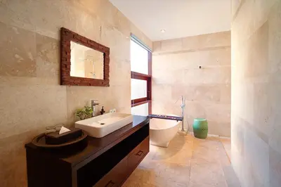 a bathroom with a sink and a toilet and a mirror at Villa Giva Seminyak - 2 Bedrooms Seminyak in Seminyak