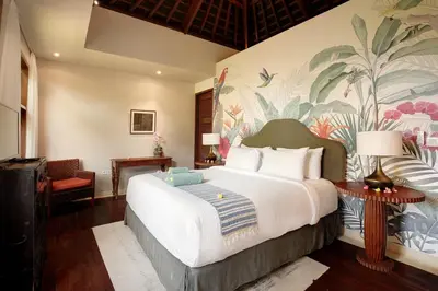 a hotel room with a bed and a mural at Villa Giva Seminyak - 2 Bedrooms Seminyak in Seminyak