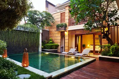 a swimming pool in the backyard of a house at Dreamscape Bali Villas Canggu in Canggu