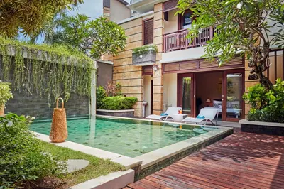 a swimming pool in the backyard of a house at Dreamscape Bali Villas Canggu in Canggu