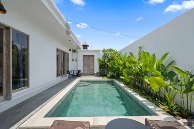 a swimming pool in the backyard of a house at Serenity Villa by Betterplace in Kerobokan