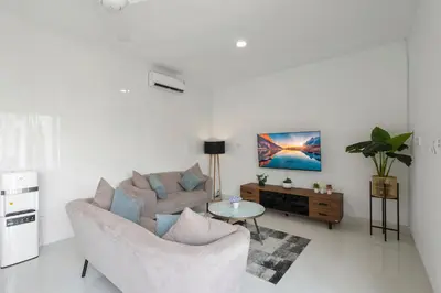 a living room with a couch and a table at Serenity Villa by Betterplace in Kerobokan