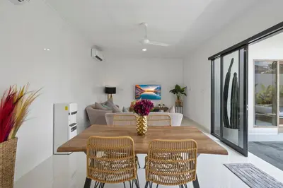 a dining room with a wooden table and chairs at Serenity Villa by Betterplace in Kerobokan
