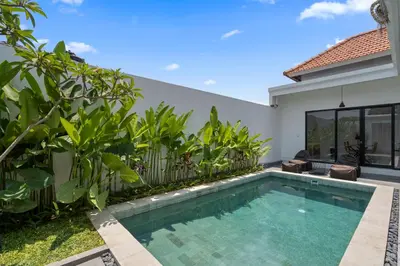 a swimming pool in the backyard of a villa at Serenity Villa by Betterplace in Kerobokan