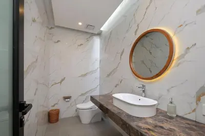 a bathroom with a sink and a mirror on the wall at Sayang Villa Bali in Kerobokan
