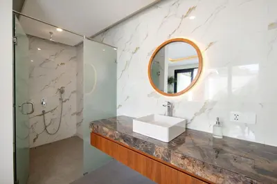 a bathroom with a sink and a mirror at Sayang Villa Bali in Kerobokan