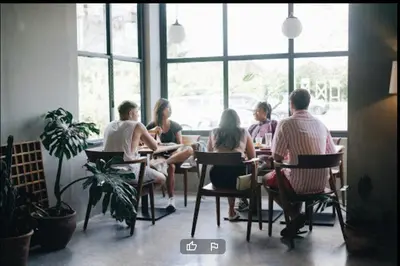 a group of people sitting at a table in a restaurant at LBV Ambengan Tenten in Denpasar