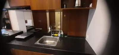 a kitchen with a sink and a black counter top at LBV Ambengan Tenten in Denpasar