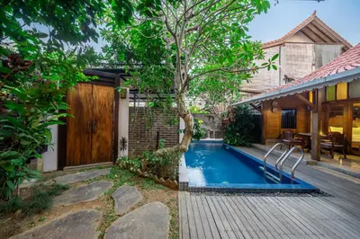 a pool in the backyard of a house at Villa Arumanis in Canggu