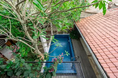 a blue door on a house with a tree at Villa Arumanis in Canggu