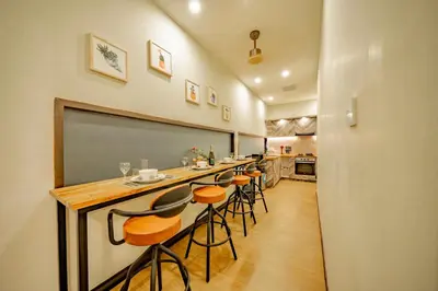 a long bar with stools in a room at Villa Domino - *NEW* Luxurious 2BR w/ Pool @Central Seminyak in Seminyak