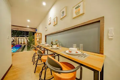 a classroom with a long table with chairs and a chalkboard at Villa Domino - *NEW* Luxurious 2BR w/ Pool @Central Seminyak in Seminyak