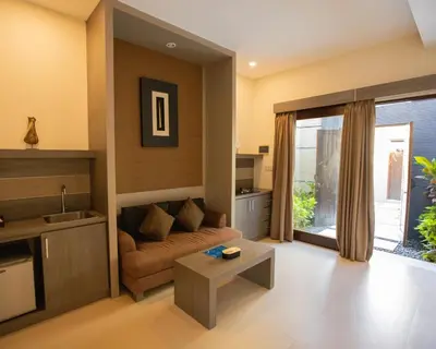 a living room with a couch and a table at Luxotic Private Villa and Resort in Nusa Dua