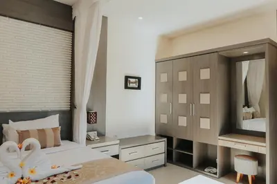 a bedroom with a bed with swans on it at Luxotic Private Villa and Resort in Nusa Dua