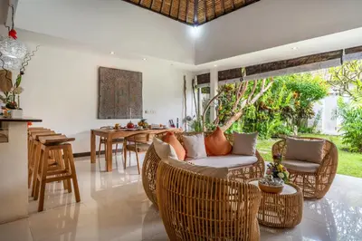 a living room with a couch and chairs and a table at Villa Ricci Seminyak in Kerobokan