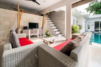 a living room with two couches and a pool at Villa Khanphi Seminyak in Seminyak
