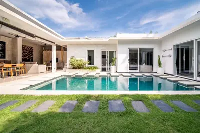 a swimming pool in the backyard of a house at Villa Khanphi Seminyak in Seminyak