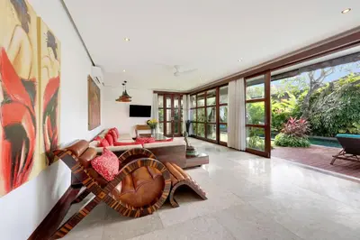 a living room with a couch and a table at Villa Amira 5BR Villa 17m Pool Near Legian Beach in Legian