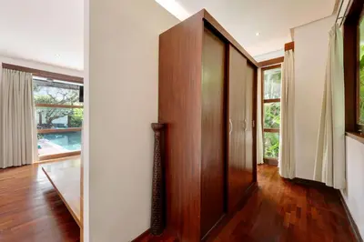 a hallway with a wooden door in a house at Villa Amira 5BR Villa 17m Pool Near Legian Beach in Legian