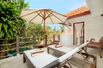 a patio with a hammock and an umbrella at Lepa Villa, Oasis in Legian in Seminyak