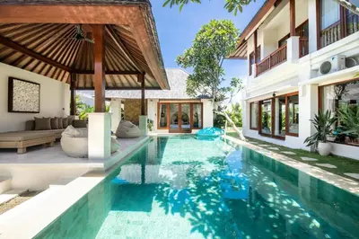 an infinity pool in the backyard of a villa at Colonial-style 4BR Villa, 400m to Canggu Beach in Canggu