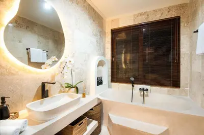 a bathroom with a large tub and a sink at Colonial-style 4BR Villa, 400m to Canggu Beach in Canggu