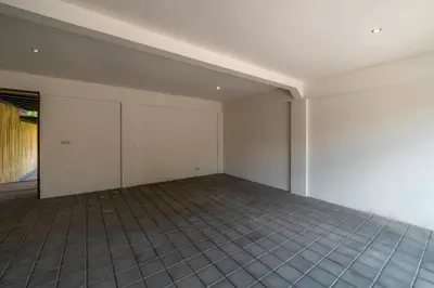 an empty room with white walls and tile floors at Villa Claudia - Chic 3BR Family Villa with Pool & Play near Seminyak in Kerobokan