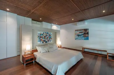 a bedroom with a large bed and two lamps at Villa Claudia - Chic 3BR Family Villa with Pool & Play near Seminyak in Kerobokan