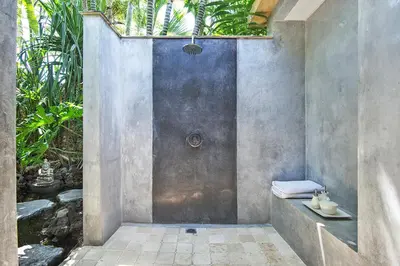a bathroom with a shower with a sink and a shower at Villa Kubu Seminyak in Seminyak
